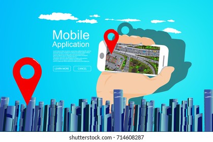 Big city scape with hand holding white mobile phone with top view city map