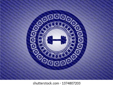 big dumbbell icon inside badge with denim texture