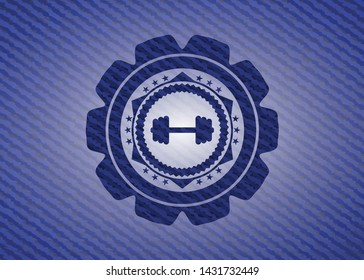 big dumbbell icon inside badge with jean texture