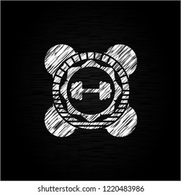 big dumbbell icon inside chalkboard emblem on black board