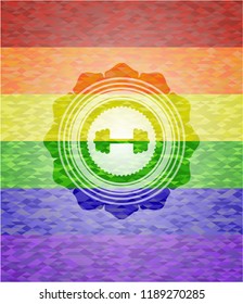 big dumbbell icon inside emblem on mosaic background with the colors of the LGBT flag