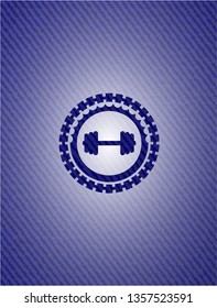 big dumbbell icon inside emblem with jean background