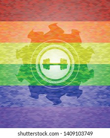 big dumbbell icon inside emblem on mosaic background with the colors of the LGBT flag