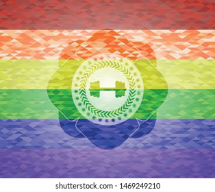 big dumbbell icon inside emblem on mosaic background with the colors of the LGBT flag