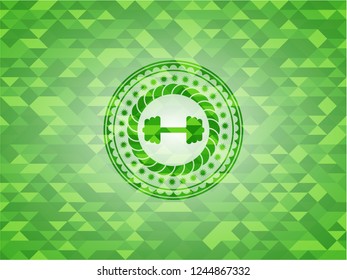big dumbbell icon inside green emblem. Mosaic background