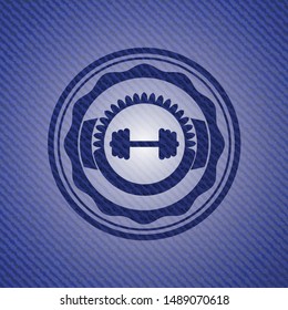 big dumbbell icon inside jean or denim emblem or badge background