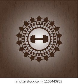 big dumbbell icon inside realistic wood emblem