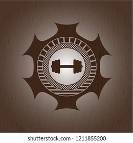 big dumbbell icon inside realistic wood emblem