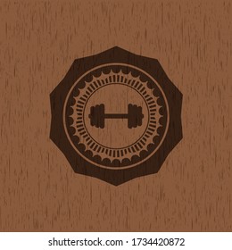 big dumbbell icon inside retro wood emblem. 