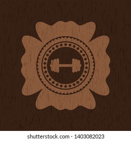 big dumbbell icon inside wooden emblem