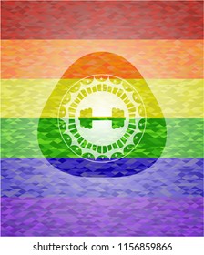 big dumbbell icon on mosaic background with the colors of the LGBT flag