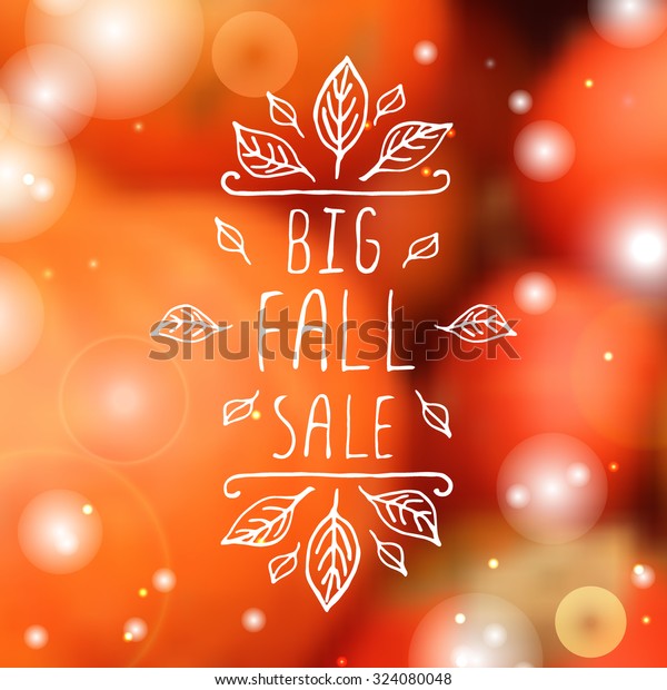 Big Fall Sale. Hand-sketched\
typographic element with orange leaves on blurred background.\
