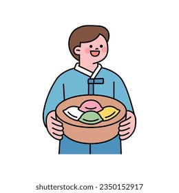 A big holiday in Korea. A boy in a traditional Korean costume is holding traditional holiday food.