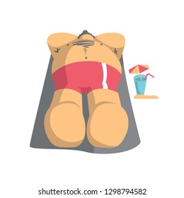 big man laying on the beach