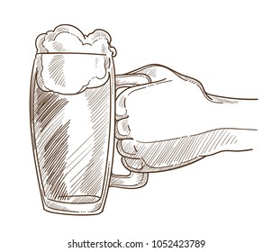 Big mug of bear with foam in male hand