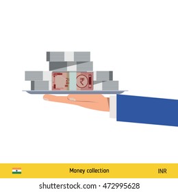 Big pile of money on the tray. Winning the jackpot. Indian Rupee banknote.