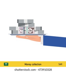 Big pile of money on the tray. Winning the jackpot. Saudi Arabian riyal banknote.