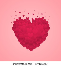 Un gran corazón rojo, que consiste de corazones pequeños, se rompe en pequeñas partículas. Día de San Valentín. Se puede usar para postales o sitios web.