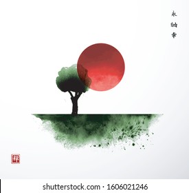 Big red sun and green tree in field. Traditional oriental ink painting sumi-e, u-sin, go-hua. Hieroglyphs - eternity, freedom, happiness, zen.