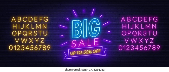 Big Sale neon sign on brick wall background.