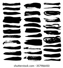 Big set of black abstract textured strokes isolated on a white background