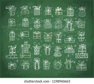 Big set of doodle christmas gift boxes on blackboard background