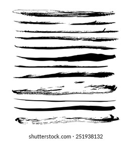 Big set of long black strokes texture in ink on white paper