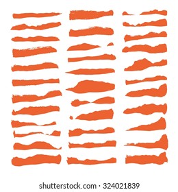 Big set of thick strokes orange paint isolated on white background