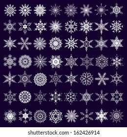 Big set of white ornate snowflakes isolated on dark background. New Year and Christmas design elements.