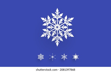 Gran copo de nieve acompañado de unos cuantos pequeños aislados en un fondo azul