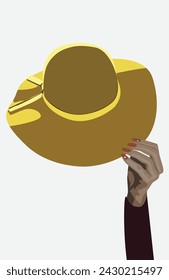Big summer yellow hat with hand holding it.