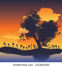 Gran silueta de árbol y hierba al atardecer.