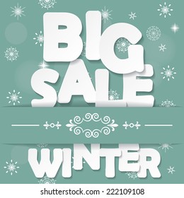 Big winter sale paper cut letters on blurred background with snowflakes. 