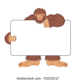 Bigfoot holding banner blank. Yeti and white blank. Abominable snowman joyful emotion. Big brown monster and place for text. Vector illustration
