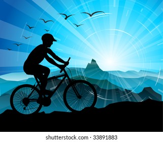 Biker Silhouette  with mountains and sunrise in the background