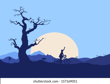 Biker Silhouette with mountains and sunset in the background