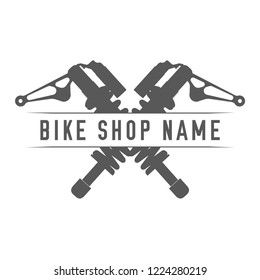 Bikes Shop Emblem. Design Element for Bike Shop or Advertising Banner. Crossed Shock Absorbers and Place for Your Bike Shop Name, Monochrome Vector Illustration.