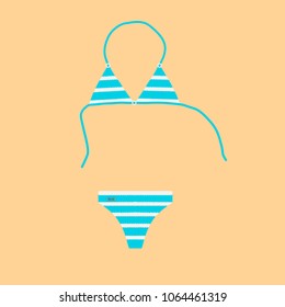 Bikini in blue and white stripes on a sand background