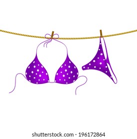 Bikini suit with white dots hanging on rope