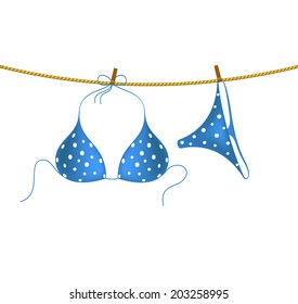 Bikini suit with white dots hanging on rope
