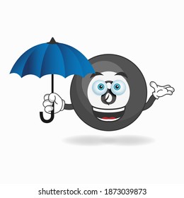 Billiard ball mascot character holding an umbrella. vector illustration