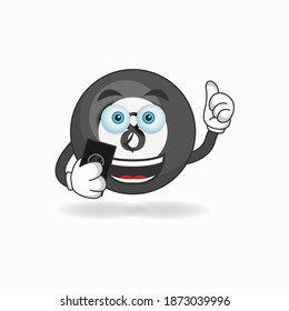 Billiard ball mascot character holding a cellphone. vector illustration