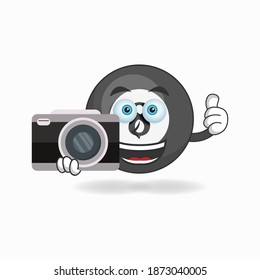 Billiard ball mascot character holding camera. vector illustration