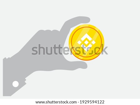 Binance's BNB Token (BNB) and crypto currency concept - hand holding golden coin - digital payment system