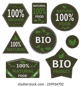 Bio labels with green leaves. Vector illustration.