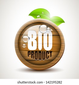BIO product - Glossy wooden icon with fresh leaves and waterdrops