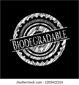 Biodegradable chalk emblem written on a blackboard