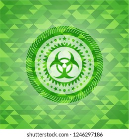 biohazard icon inside green emblem with triangle mosaic background