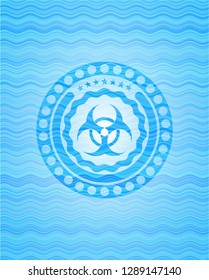 biohazard icon inside sky blue water wave style emblem.