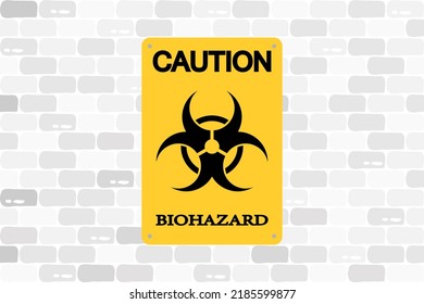 Biohazard vector warning sign, black and yellow banner screwed to a brick wall.